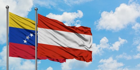 Venezuela and Austria flag waving in the wind against white cloudy blue sky together. Diplomacy concept, international relations.