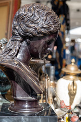 Stone statuette of woman at flea market