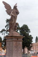 Obraz premium Christian Statue in the Day of Commemoration of the Dead in Italian Cemetery