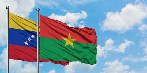 Venezuela and Burkina Faso flag waving in the wind against white cloudy blue sky together. Diplomacy concept, international relations.