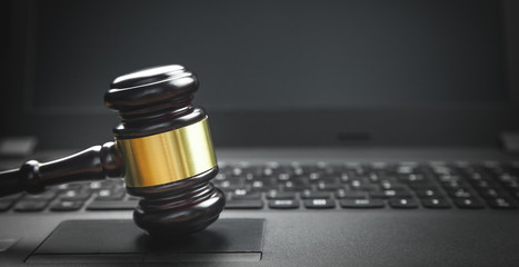 Judge gavel on laptop keyboard. Internet crime