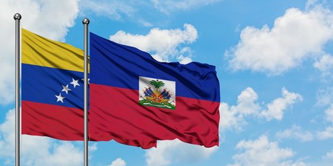 Venezuela and Haiti flag waving in the wind against white cloudy blue sky together. Diplomacy concept, international relations.
