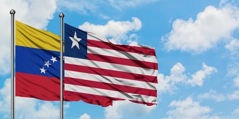 Venezuela and Liberia flag waving in the wind against white cloudy blue sky together. Diplomacy concept, international relations.