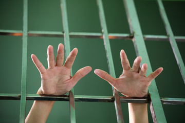 close up of prisoner hand in jail