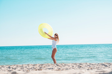Girl goes swimming on the beach with a rubber ring