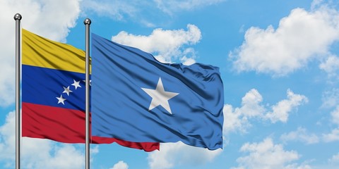 Venezuela and Somalia flag waving in the wind against white cloudy blue sky together. Diplomacy concept, international relations.