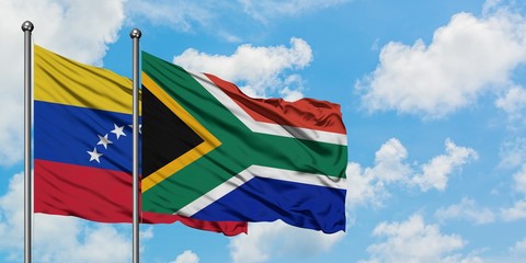 Venezuela and South Africa flag waving in the wind against white cloudy blue sky together. Diplomacy concept, international relations.