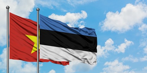 Vietnam and Estonia flag waving in the wind against white cloudy blue sky together. Diplomacy concept, international relations.