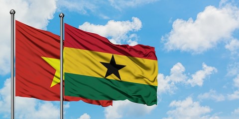 Vietnam and Ghana flag waving in the wind against white cloudy blue sky together. Diplomacy concept, international relations.