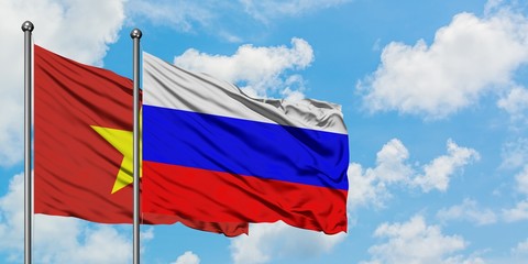 Vietnam and Russia flag waving in the wind against white cloudy blue sky together. Diplomacy concept, international relations.