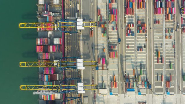 Hyperlapse Aerial view of international port with Crane loading containers in import export business logistics. footage video 4k. industry logistics seaport. Business Import and export. Economic trade