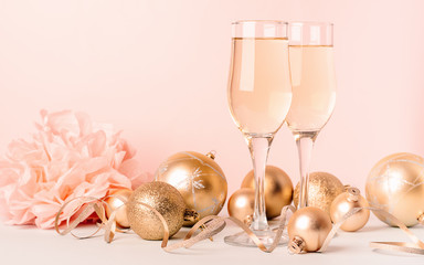 Champagne in glass goblets gold balloons stars serpentine a pastel delicate pink background. New...
