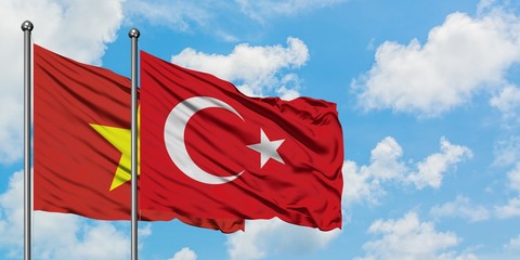 Vietnam and Turkey flag waving in the wind against white cloudy blue sky together. Diplomacy concept, international relations.