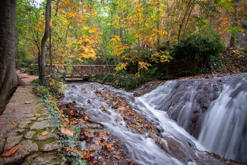 river with waterfall in the autumn season