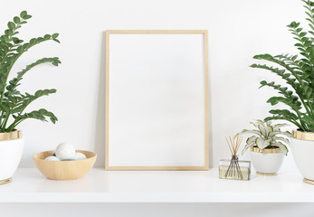 Golden frame leaning on white shelve in bright interior with plants mockup 3D rendering