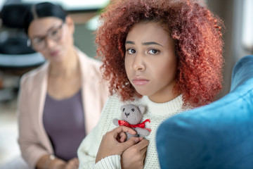 Young woman sharing memories about baby with psychoanalyst