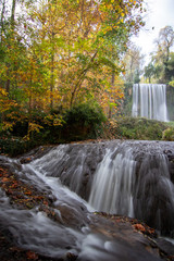 river with waterfall in the autumn season