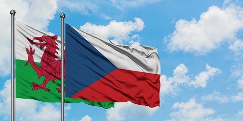 Wales and Czech Republic flag waving in the wind against white cloudy blue sky together. Diplomacy concept, international relations.