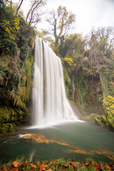 river with waterfall in the autumn season