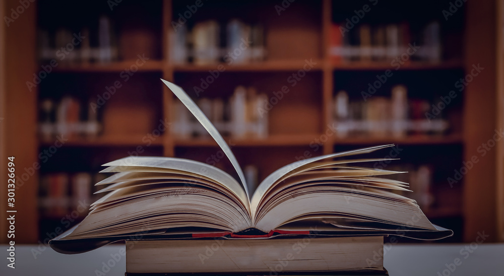 Poster stack of books in the library and blur bookshelf background