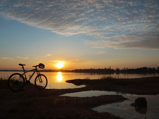 Fototapeta premium Mountain bike parked beside the reservoir in the morning