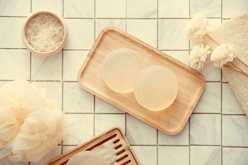 Natural soap and salt on a wooden board, hygiene items for bath and spa.