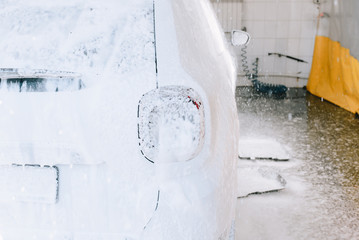 White car at the sink in the foam