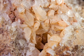 Natural quartz crystals grow from a stone block close up