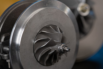 part of aluminum turbine close up. the new turbine for the diesel engine on a car workshop...