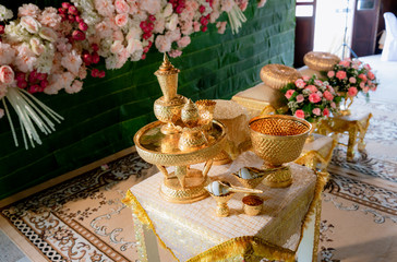 Thai wedding accessory for cultural wedding ceremony, luxury chair for bride and groom, golden tray with pedestal and the others. image for wedding objects, copy space and advertisement.