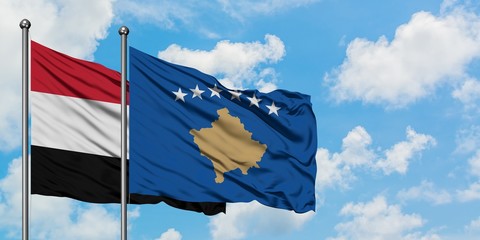 Yemen and Kosovo flag waving in the wind against white cloudy blue sky together. Diplomacy concept, international relations.