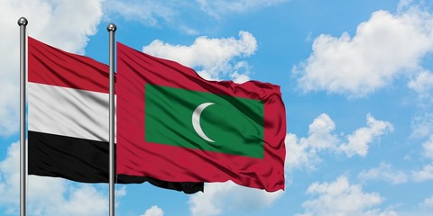 Yemen and Maldives flag waving in the wind against white cloudy blue sky together. Diplomacy...