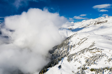 Fototapeta na wymiar Clouds in the Swiss Alps in winter. Aletsch arena, Bettmeralp, Switzerland