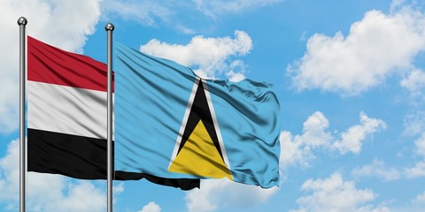 Yemen and Saint Lucia flag waving in the wind against white cloudy blue sky together. Diplomacy concept, international relations.