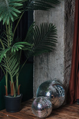 Palm tree in a pot with silver mirror disco balls 