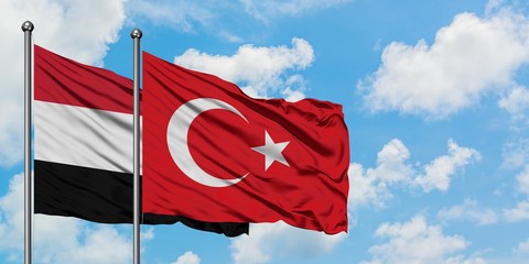 Yemen and Turkey flag waving in the wind against white cloudy blue sky together. Diplomacy concept, international relations.