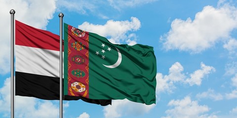 Yemen and Turkmenistan flag waving in the wind against white cloudy blue sky together. Diplomacy concept, international relations.