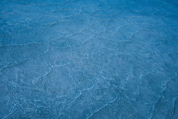 Pattern of sea waves toned in light blue