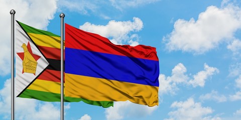 Zimbabwe and Armenia flag waving in the wind against white cloudy blue sky together. Diplomacy concept, international relations.