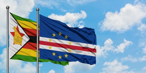 Zimbabwe and Cape Verde flag waving in the wind against white cloudy blue sky together. Diplomacy concept, international relations.