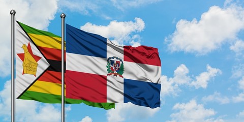 Zimbabwe and Dominican Republic flag waving in the wind against white cloudy blue sky together. Diplomacy concept, international relations.