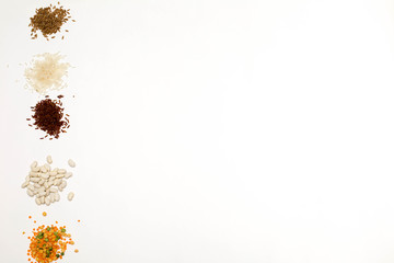 Different kinds of cereals and beans on a white background. Flatley horizontal
