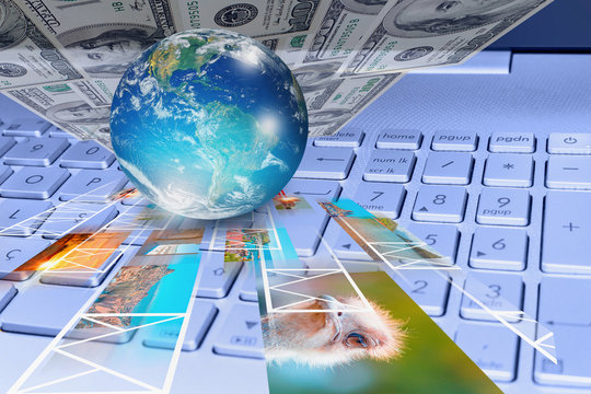 Stock photography concept - Glass globe on the computer keyboard with photo and dollars "Elements of this image furnished by NASA "