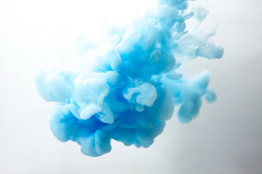 Abstract Flowing Liquid Or Blue Ink In Water On A White Background. It Looks Like Smoke Or Cloud. Or Zero Gravity.