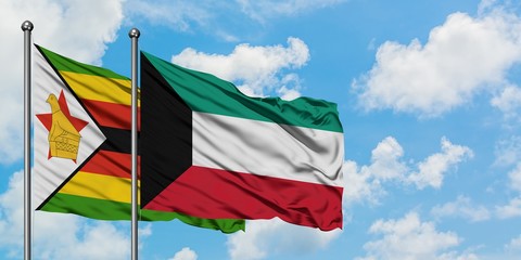 Zimbabwe and Kuwait flag waving in the wind against white cloudy blue sky together. Diplomacy concept, international relations.