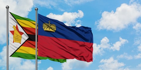 Zimbabwe and Liechtenstein flag waving in the wind against white cloudy blue sky together. Diplomacy concept, international relations.