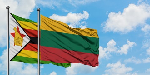 Zimbabwe and Lithuania flag waving in the wind against white cloudy blue sky together. Diplomacy concept, international relations.