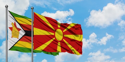 Zimbabwe and Macedonia flag waving in the wind against white cloudy blue sky together. Diplomacy concept, international relations.