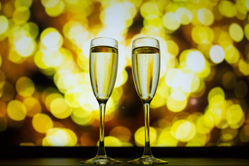 Two glasses of champagne on a bokeh background. Close-up isolated background.