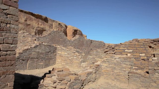 Panning around the ruins of Chetro Ketl at Chaco Canyon in New Mexico. The walls were built almost a thousand years ago by the Anasazi people. The cool brick walls still stand. May have been religious